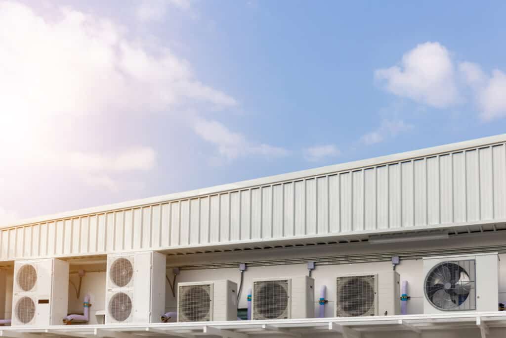 group external air conditioning compressors units outside building with blue sky background